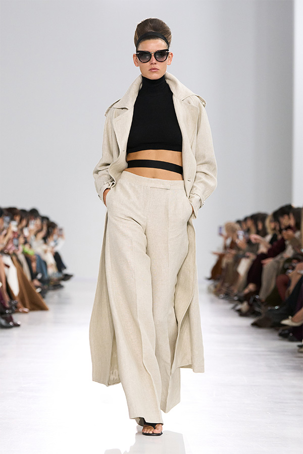 Max Mara Spring/Summer 2026 Fashion Show - Look with black turtleneck under Trench coat and matching Trousers.